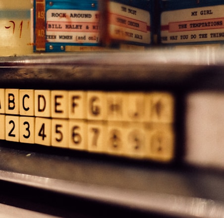 selective focus photo of alphabet and latter tile