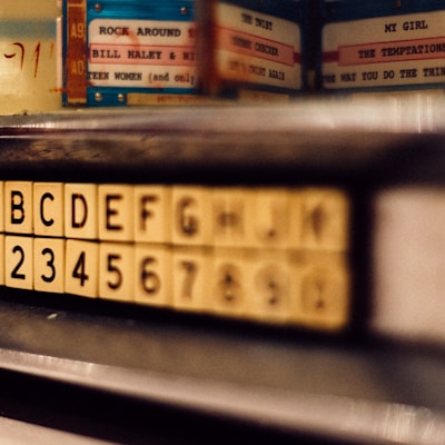 selective focus photo of alphabet and latter tile