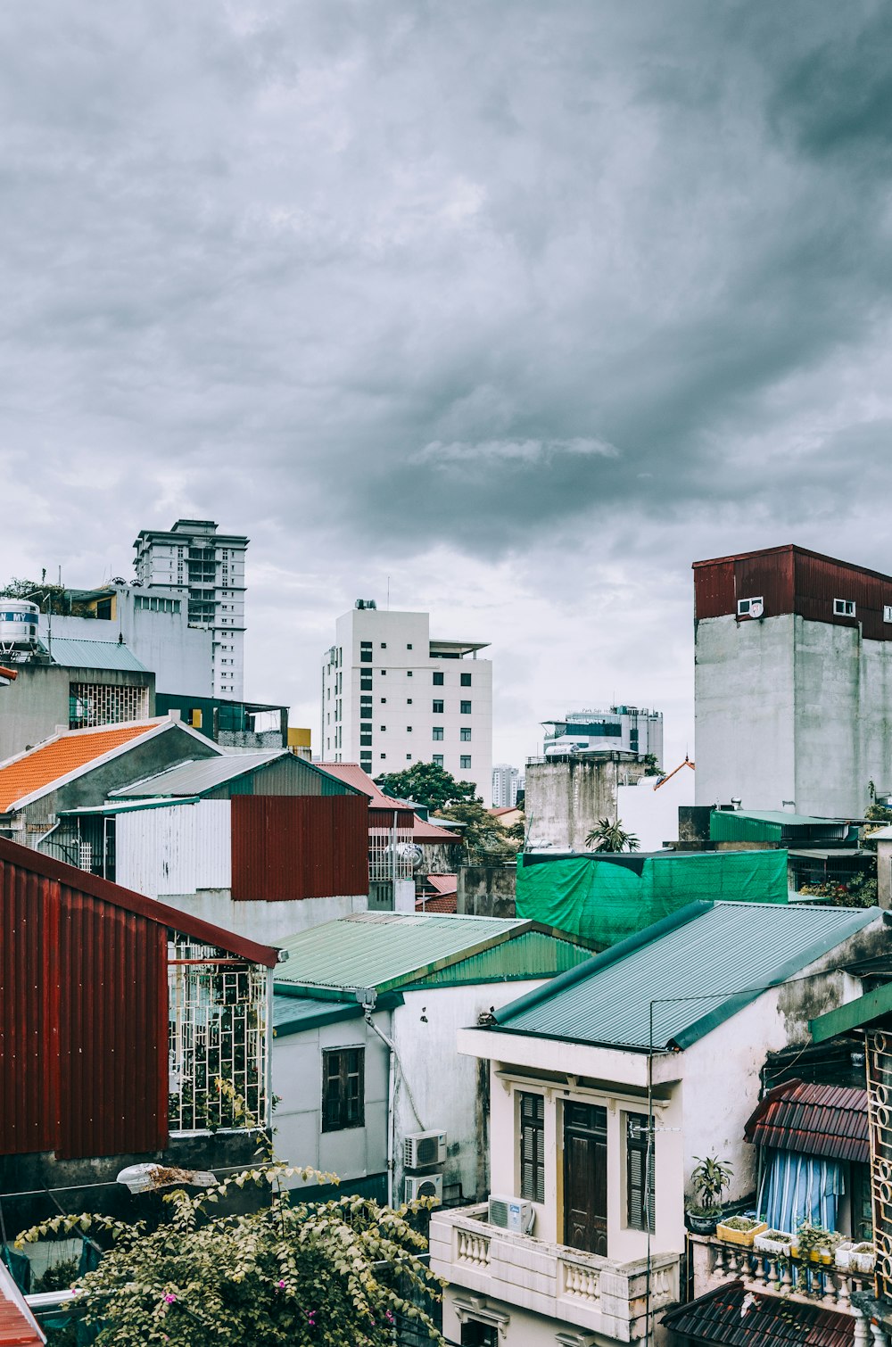 white and gray concrete mid-rise buildings under gray clouds