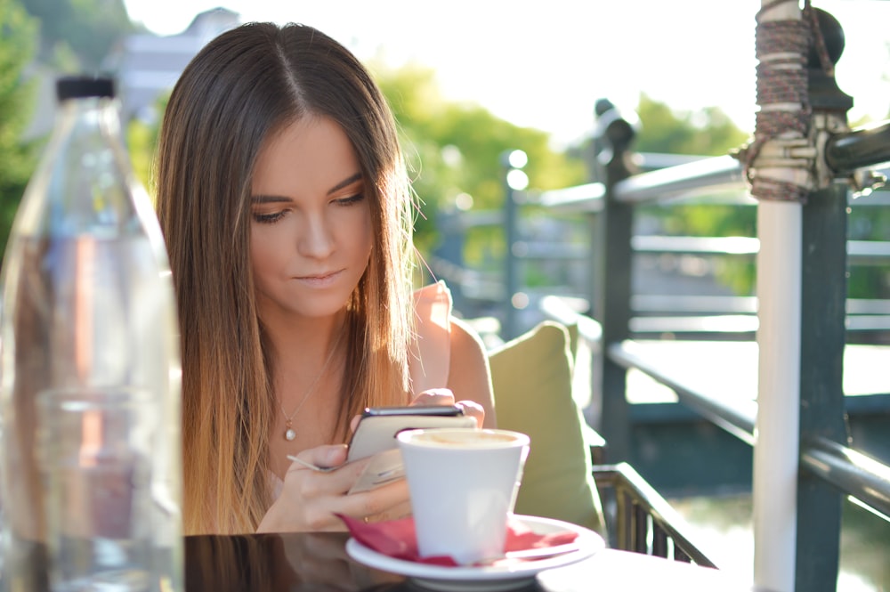 woman sitting on side of railings