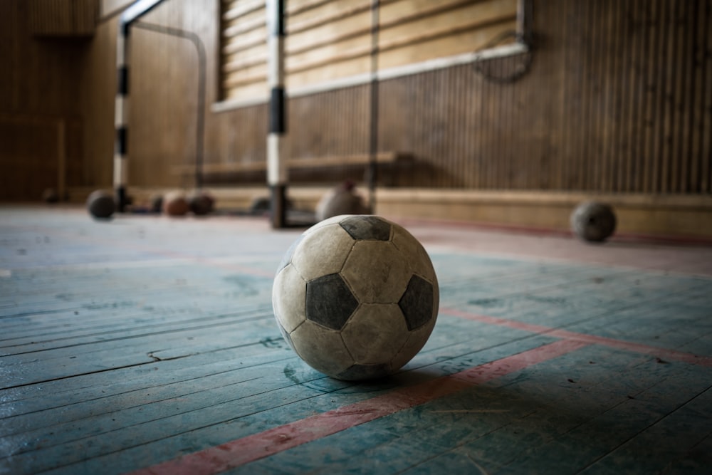 white and black soccer ball on blue surface