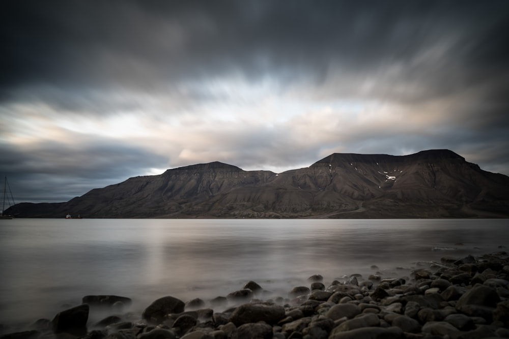 mountain near ocean during daytime