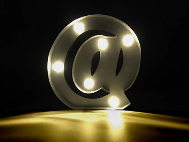 Bright neon yellow social media icons glowing against a dark background.