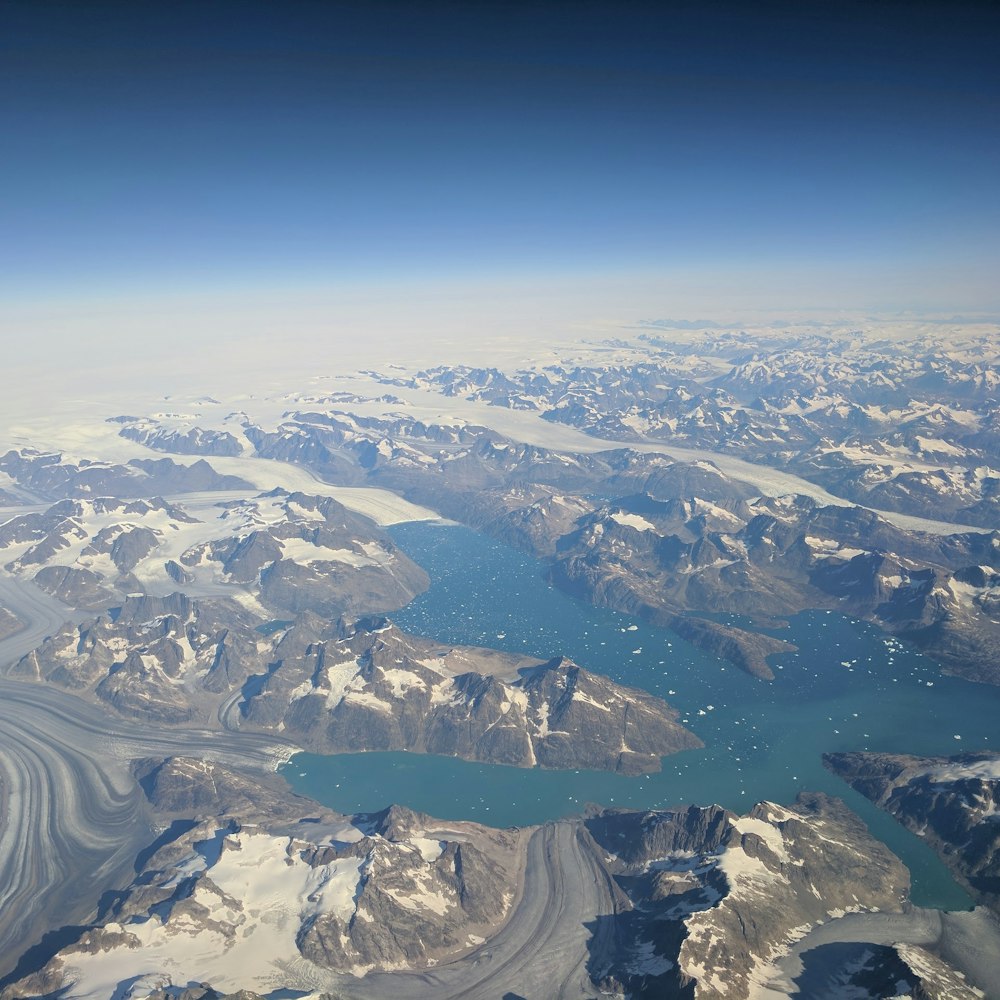 aerial photo of gray mountain near body of water