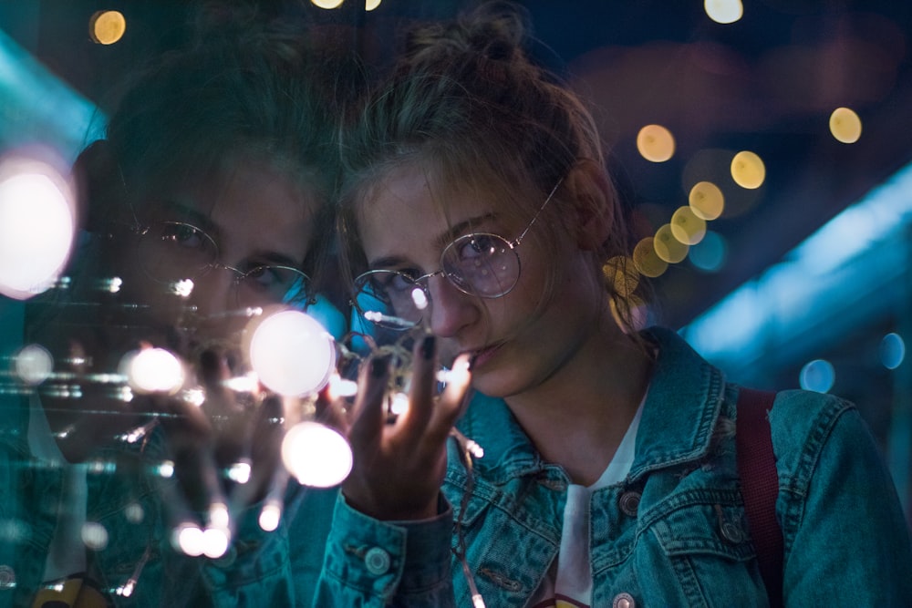 photo of woman showing hand during night time