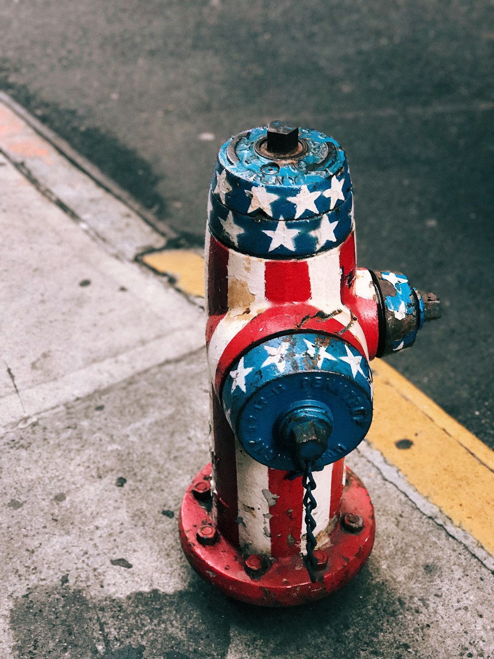 multicolored American flag painted fire hydrant at daytime
