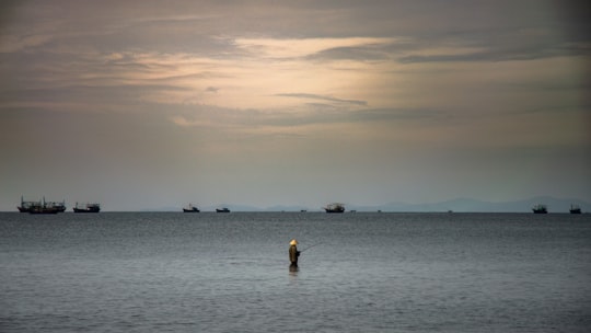 person fishing in the middle of body of water in Quỳnh Lưu District Vietnam