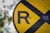 closeup photo of yellow and blue R road signage