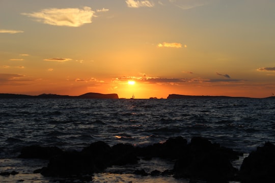 silhouette photo of rippling body of water at golden hour in Ibiza Spain