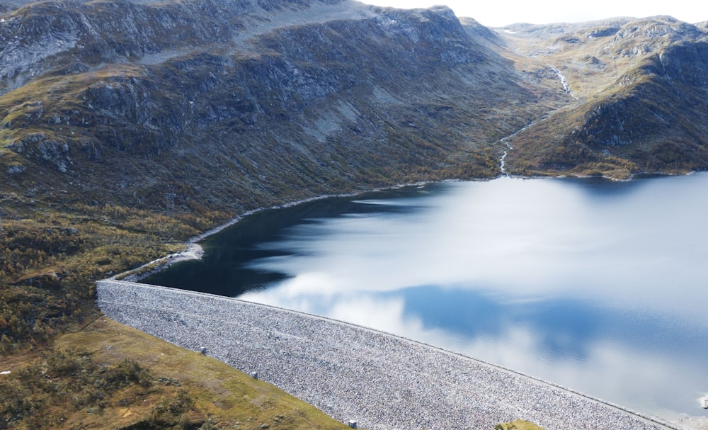 body of water beside mountain