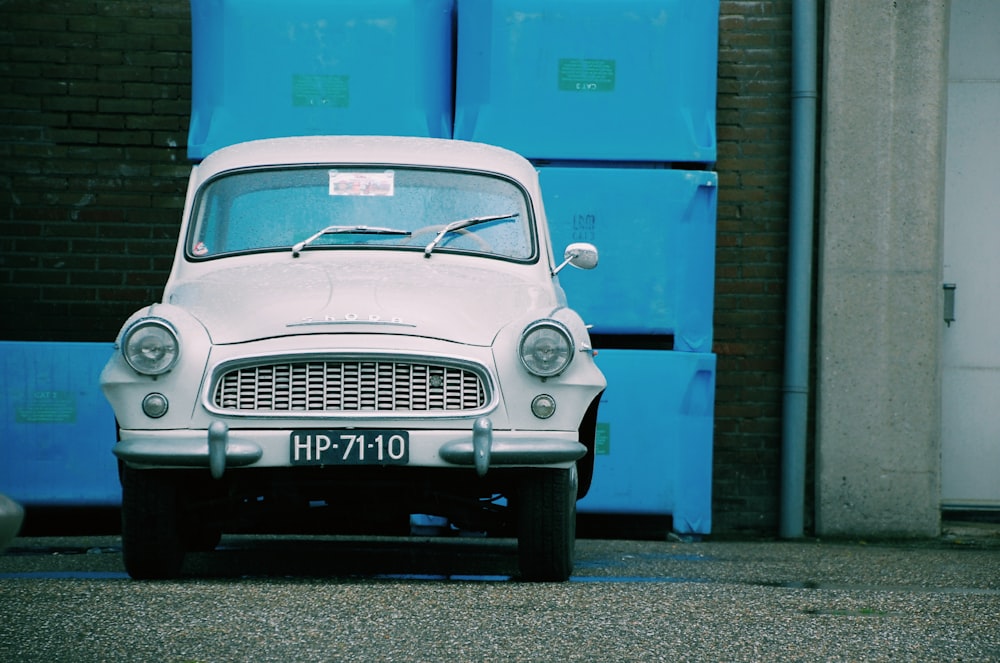 white car near concrete building