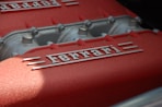 close-up photography of gray and red Ferrari engine