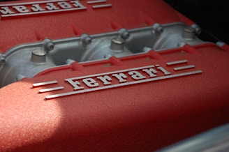 close-up photography of gray and red Ferrari engine