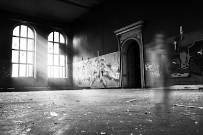 An ancient abandoned house with eerie shadows and a glowing orb near the window.