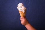 children holding brown ice cream cone with strawberry icecream