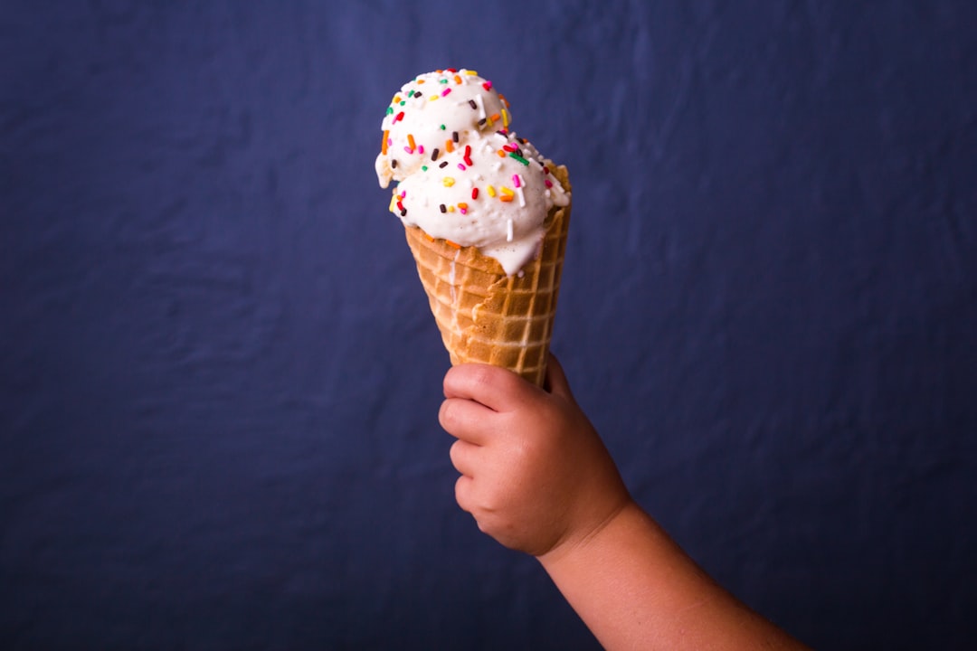 children holding brown ice cream cone with strawberry icecream, Toddler holding ice cream cone with sprinkles