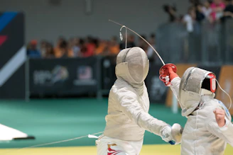 two person fencing inside the gym