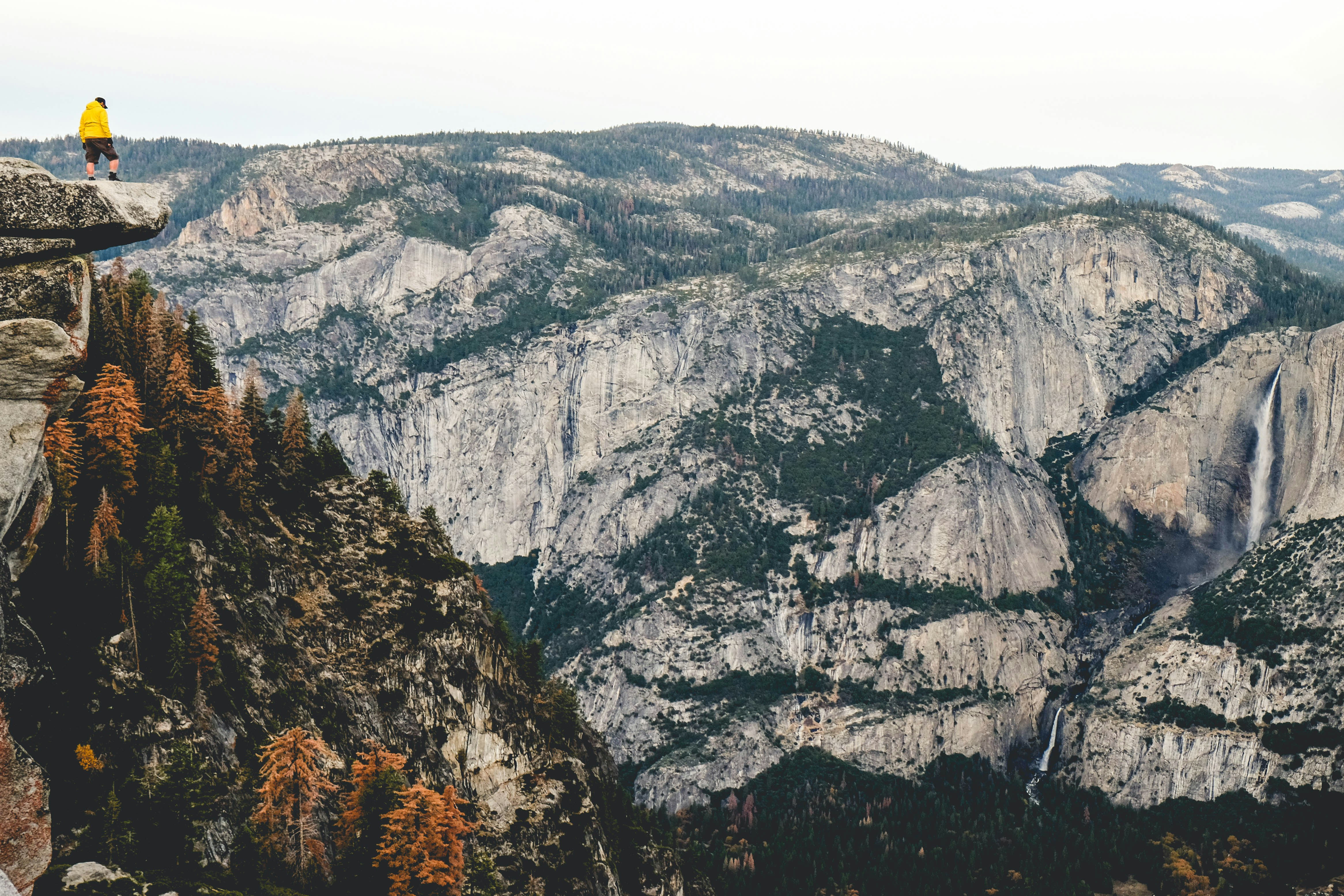person standing on cliff under cloudy skies, It was my first visit to Yosemite National Park. I hiked 4.7 miles with some friends uphill, it was tiring but we were rewarded with this absolutely breathtaking view. I was amazed by nature’s stunning gifts. Earth is a beautiful place and more people need to remember this.