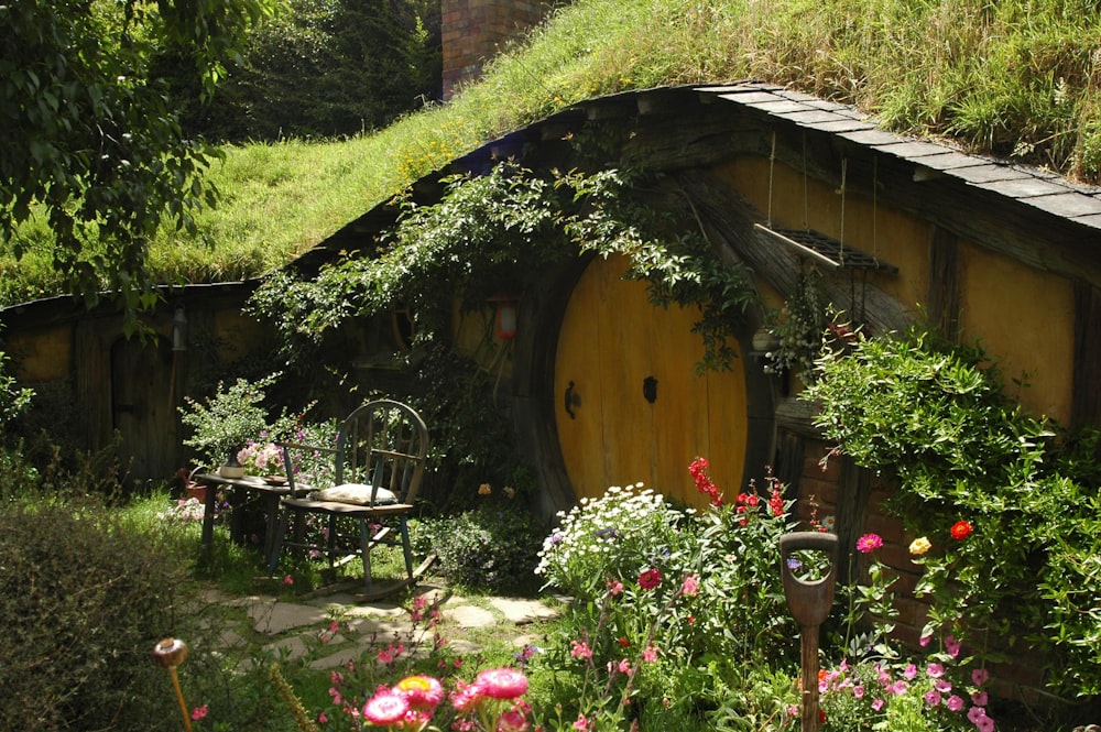 brown and black wooden house with garden