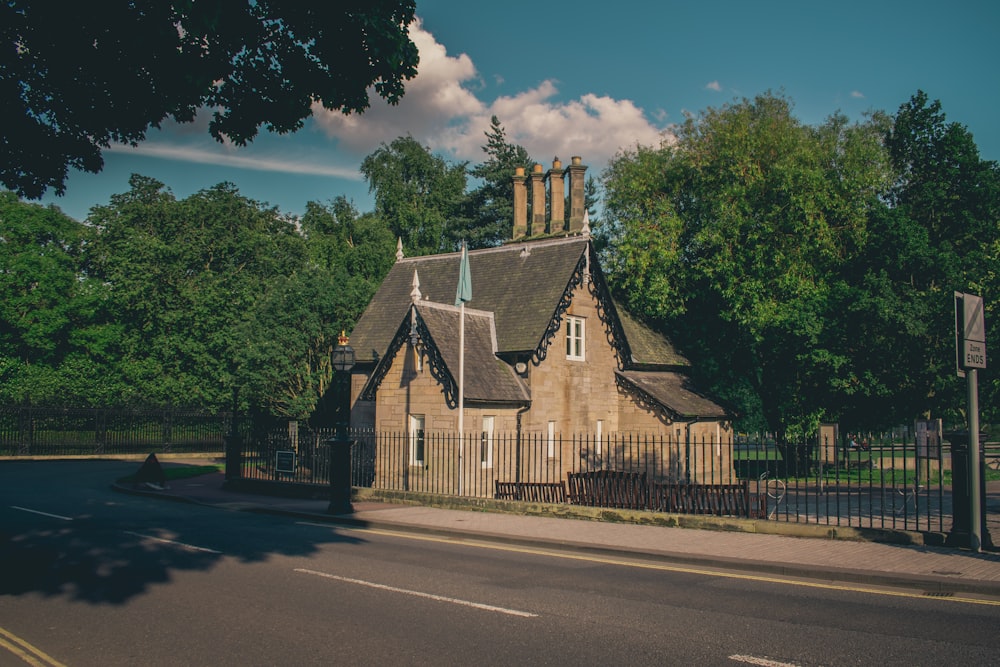 brown house beside road during daytime