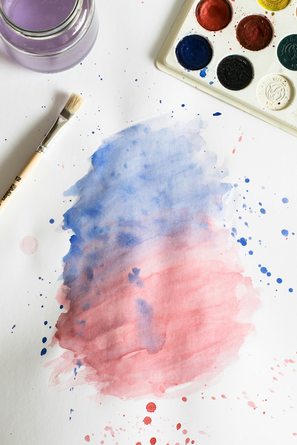 a watercolor painting of a red, white and blue cloud