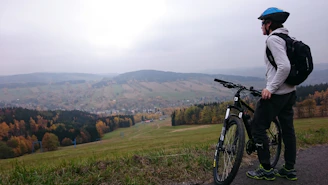 A candid shot showing a scenic stopover spot with a packed backpack and helmet resting on a bench.