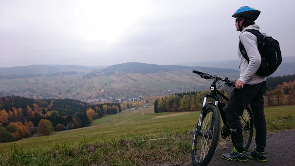 A candid shot showing a scenic stopover spot with a packed backpack and helmet resting on a bench.