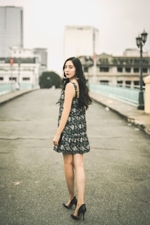 A model walking down a city street wearing a vibrant patterned dress.