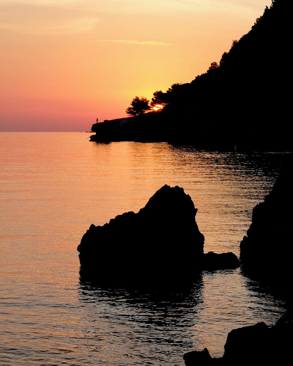 brown stone near the island during golden hour photography