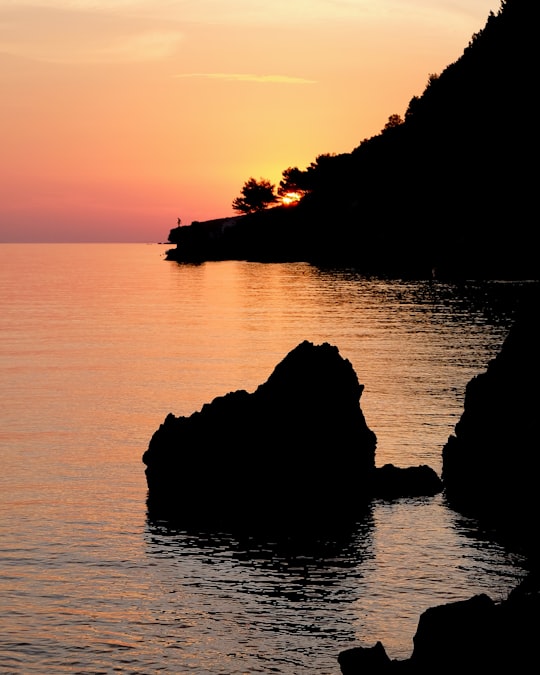 brown stone near the island during golden hour photography in Marušići Croatia