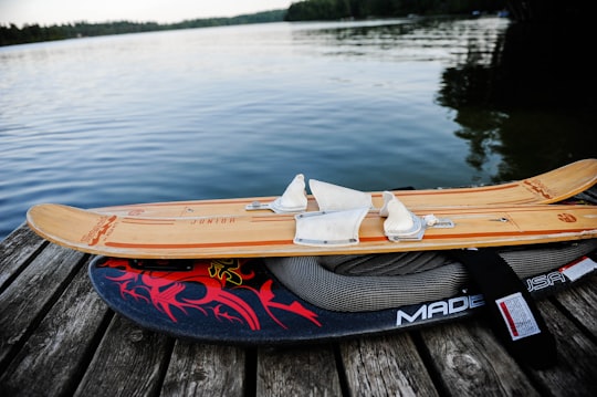 brown water ski on gray wooden dock near body of water in Bancroft Canada