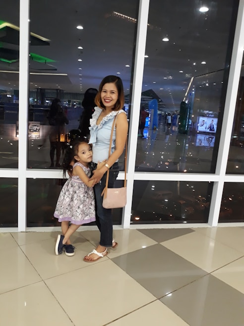 Mother and daughter sharing a warm hug while choosing clothes in a cozy boutique