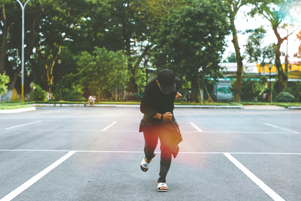 man standing on parking lot