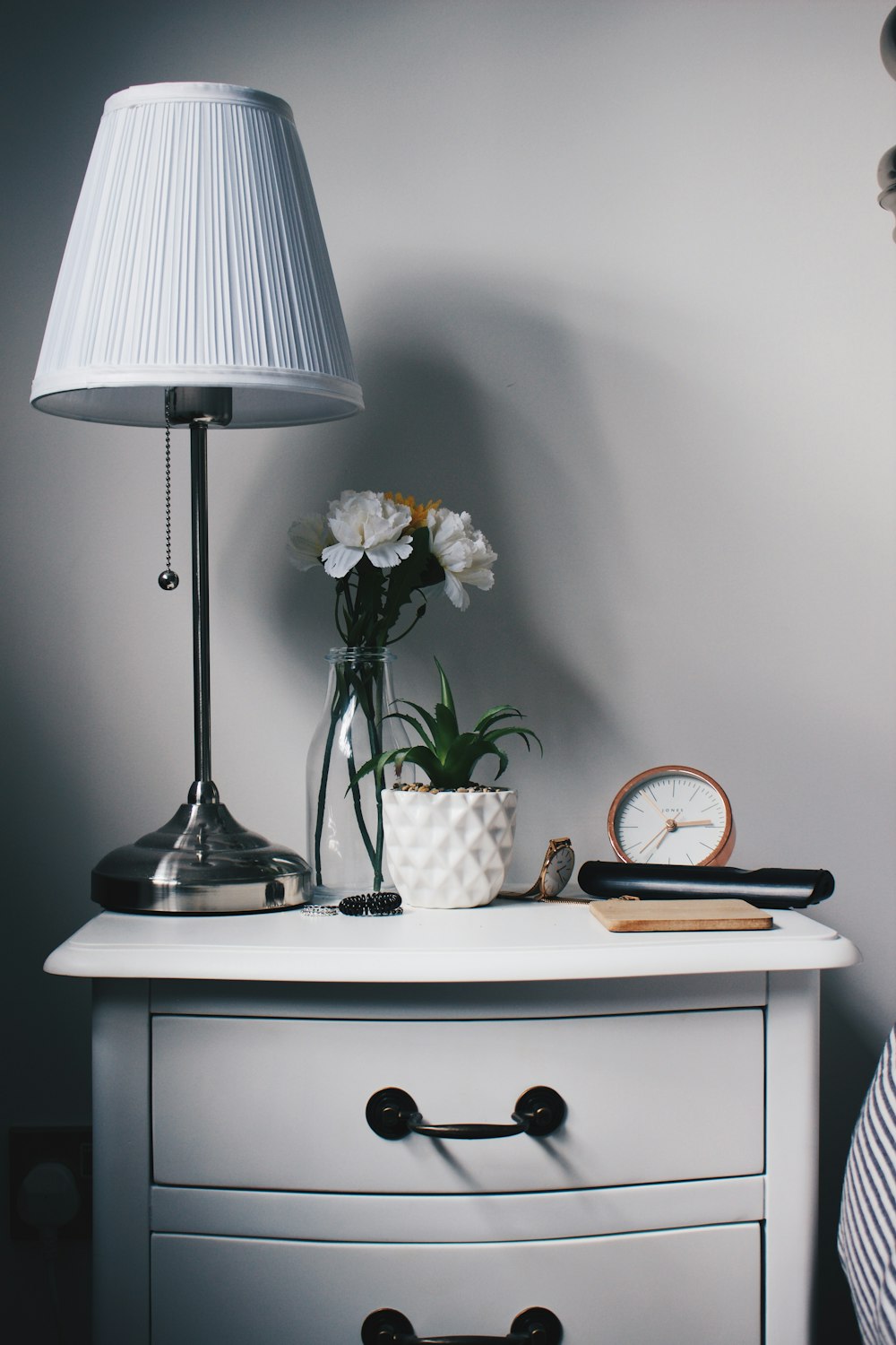 gray metal base white lampshade on nightstand