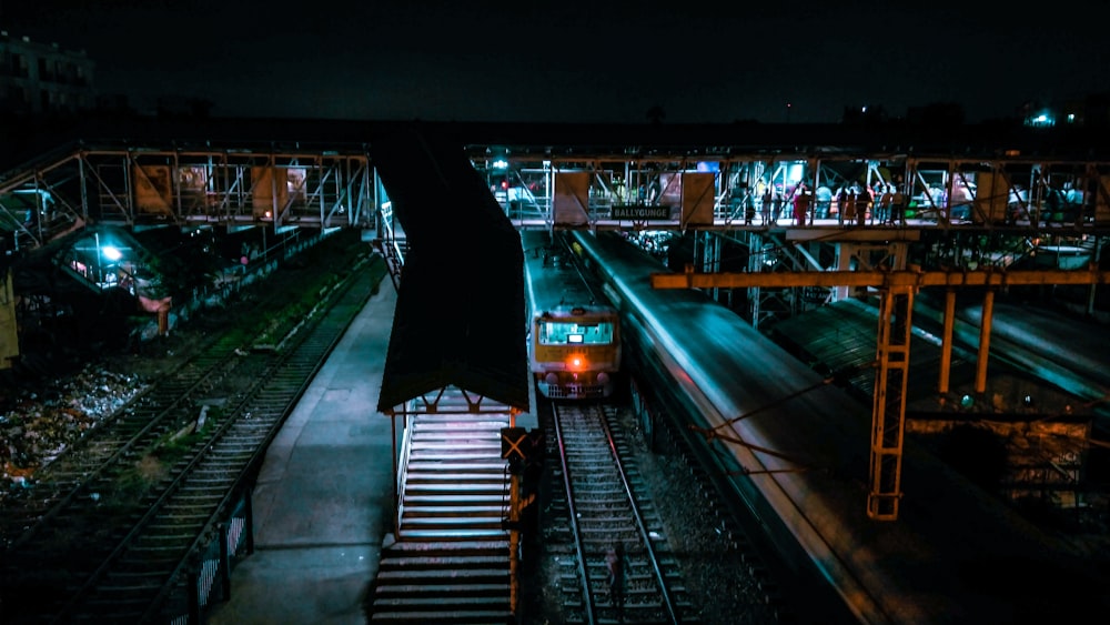 a train traveling down train tracks at night