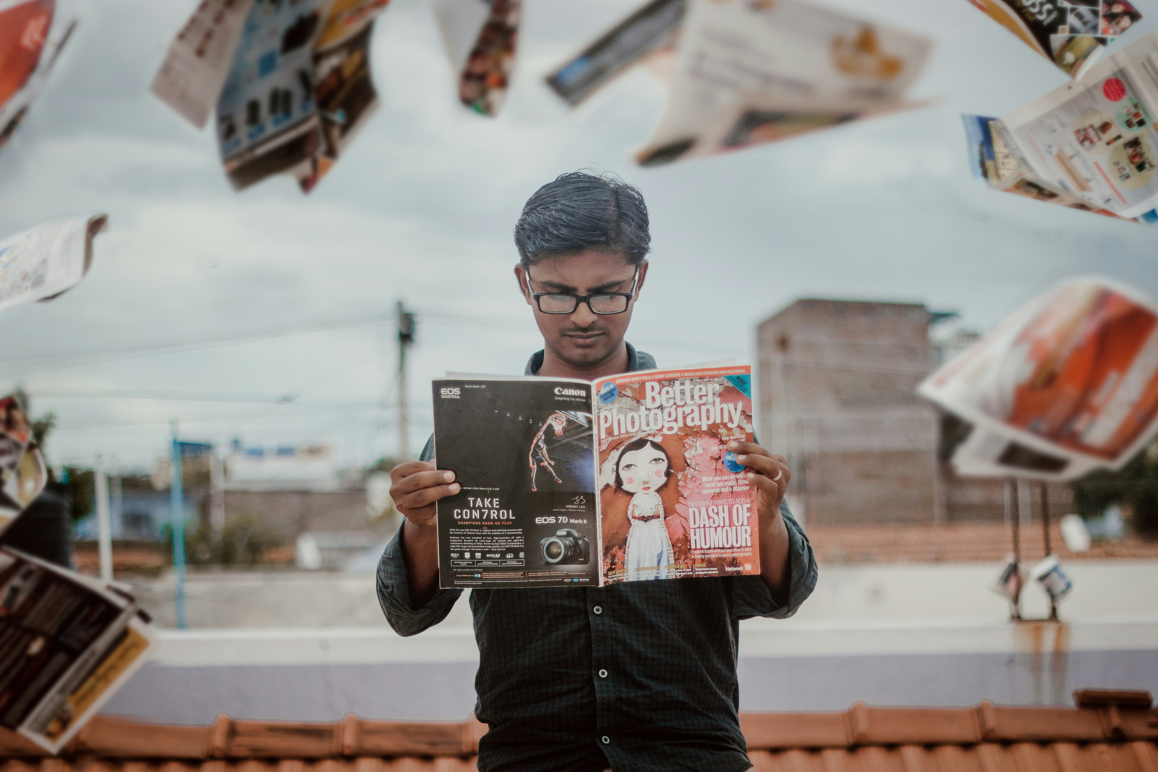 man reading magazine while standing