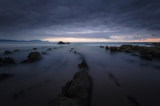 misty rock formation during daytime in Barrika Spain