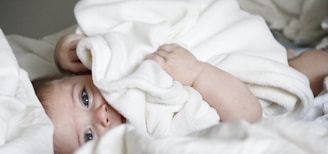 baby laying on bed