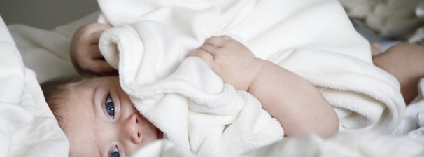 baby laying on bed