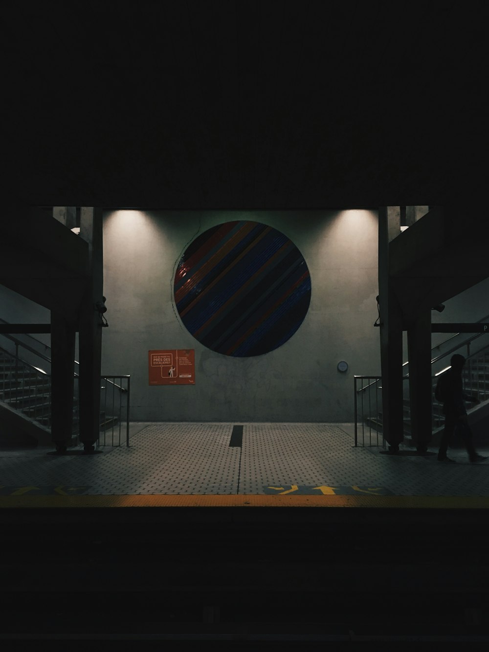 silhouette photo of man walking inside building