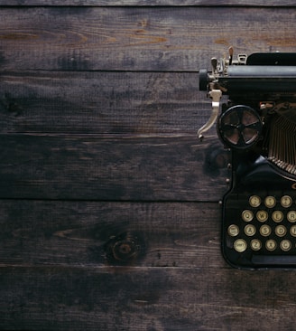 black Corona typewriter on brown wood planks