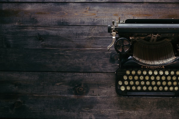 black Corona typewriter on brown wood planks photo – Free Writing Image on Unsplash