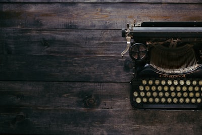 black corona typewriter on brown wood planks blog google meet background