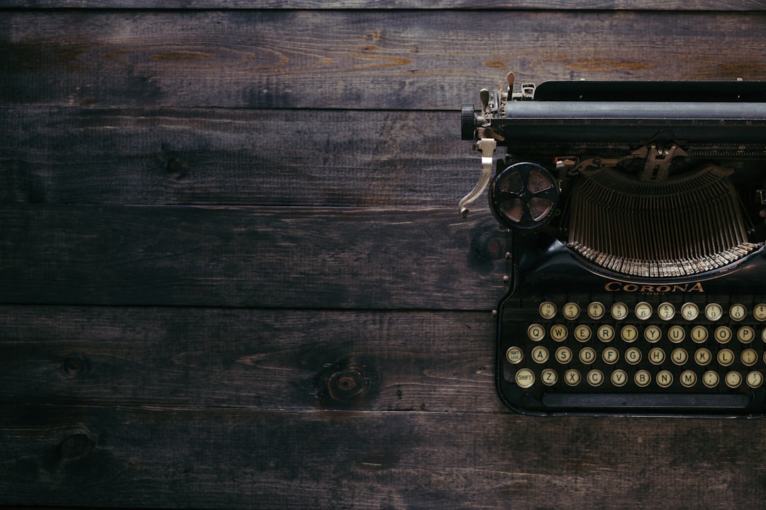 black Corona typewriter on brown wood planks, Antique Typewriter on Dark Wood