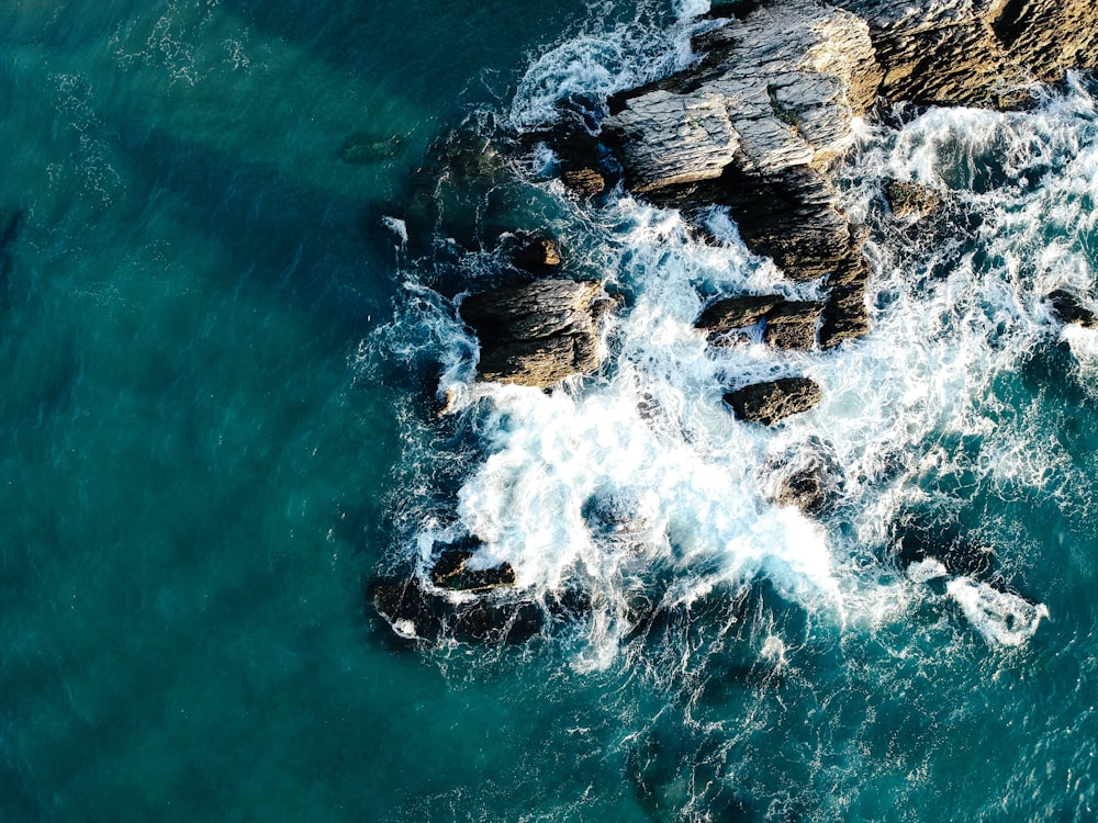aerial view photo of rocks near body of water