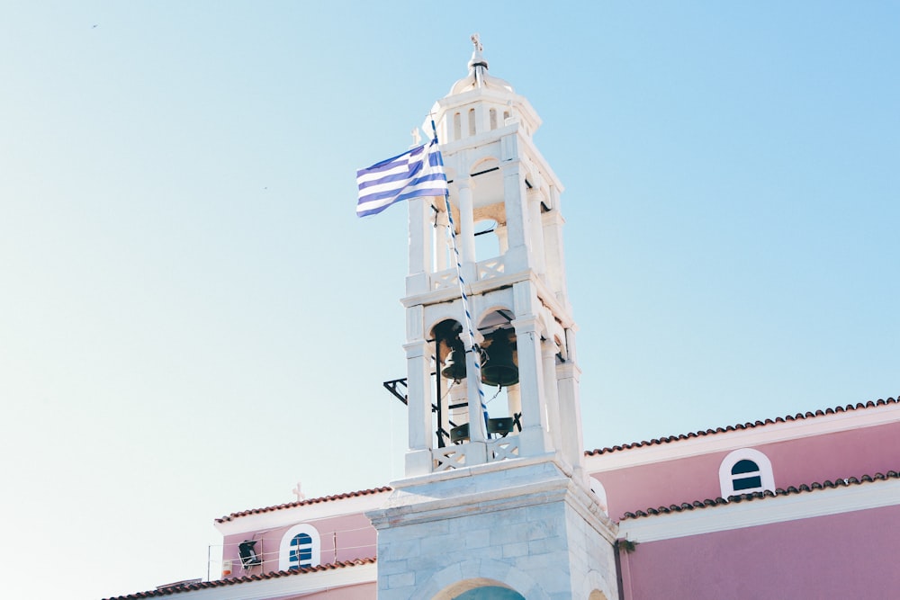 blue and white striped flag placed on white tower