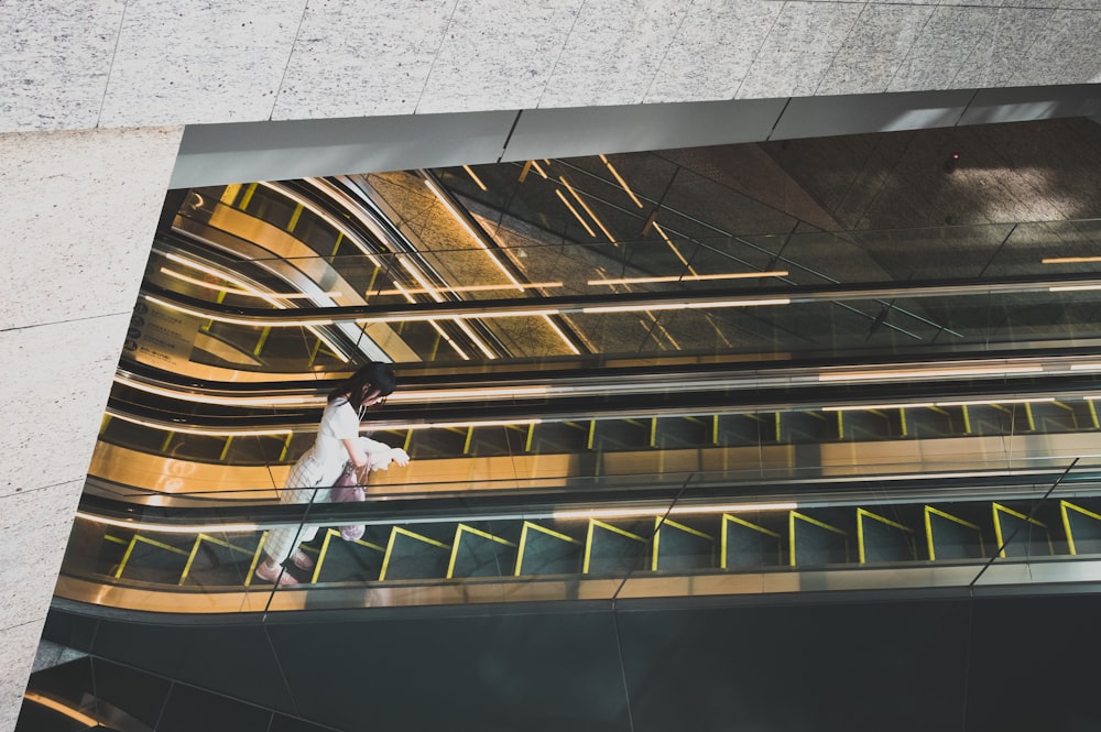 woman standing on escalator photography