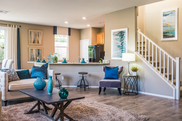 A living room with a sofa, coffee table, and open kitchen area