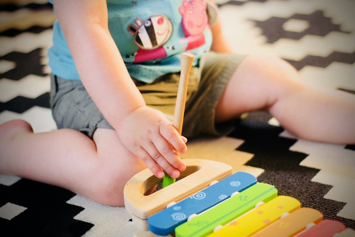 A young child playing on a soft carpet