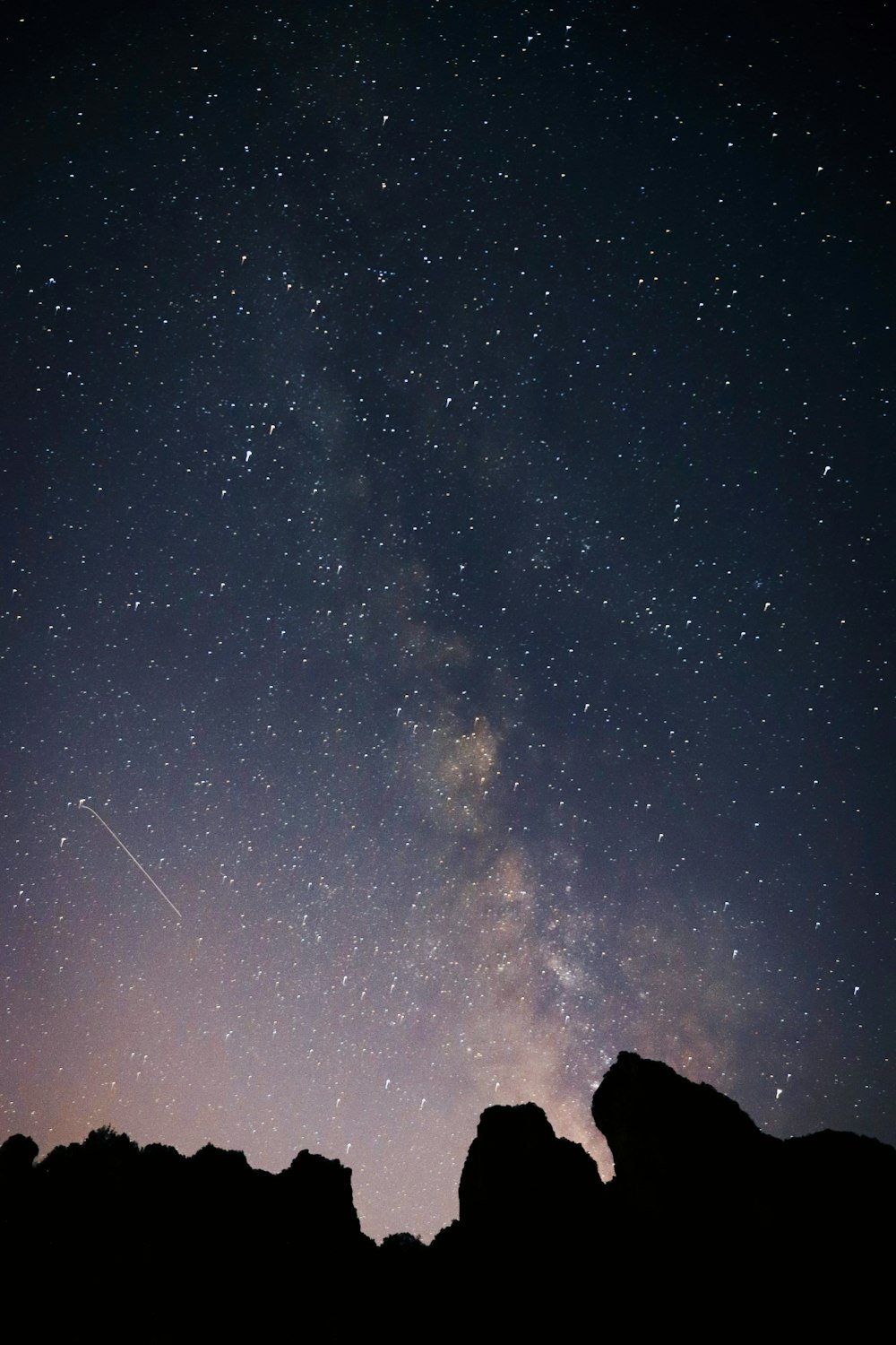 silhouette photo of mountains under starry night